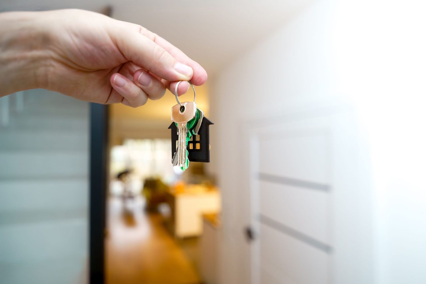 Hand holding a house-shaped keychain